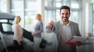 A smiling car salesman